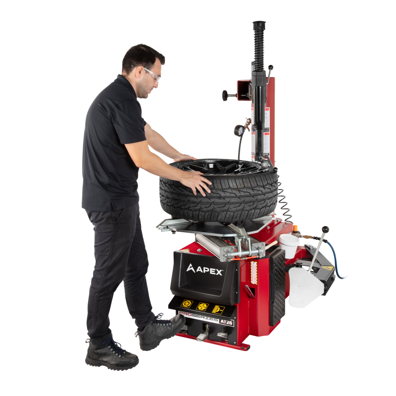 APEX AT26 tire changer showing high-torque electric turntable and swing arm design