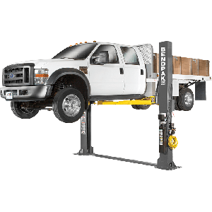 Full system view of the BendPak XPR-12FDL lifting a work truck on its 12,000-lb floor-plate two-post platform, designed for commercial bays and fleet service. SKU 5175403